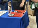 Attendees take turns thumbing through the 19th edition of Hints and Kinks, The POTA Book, and ARRL’s Tech-through-Amateur Extra license manuals.