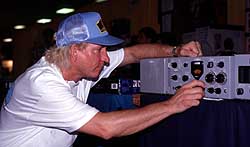 Hamvention 99 entertainer Joe Walsh, WB6ACU, checks out the vintage Collins KWM-1 transceiver he bought.