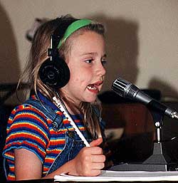 Karin Greene, daughter of Clarke Greene, K1JX, in Middletown, Connecticut, really gets into Kid's Day. Maybe some of the headphone manufacturers will soon start experimenting with sales of colorful headphones just for kids!