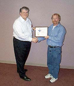 New England Division Volunteer of the Year Jim Heedles, WW1Y (right), receives an award certificate from New England Director Tom Frenaye, K1KI. [Photo courtesy of Tom Frenaye, K1KI]