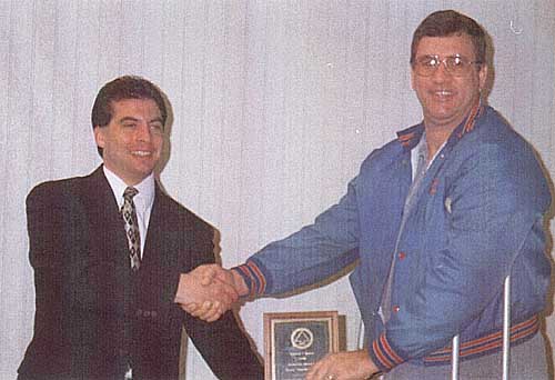 Lonnie McVaigh, KB9LUN (right), receives the 1998 Samuel I. Keene Memorial Award for Heroic Disaster Service